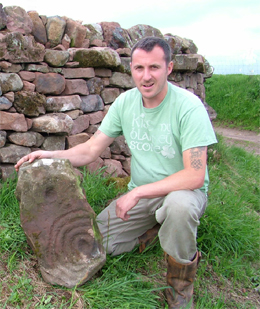 The finder Austen Reid with the cup and ring stone at Dunsyre 