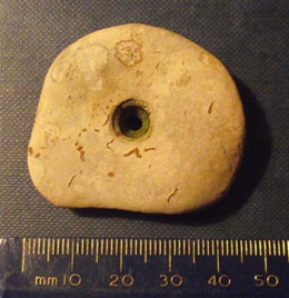 A random but nice little 'hour glass' perforated greywacke stone , of unknown but early pre historic date, probably an amulet