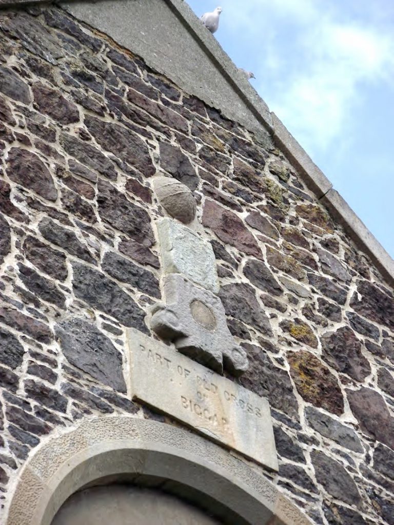 Parts of the cross embedded in the south gable of the Corn Exchange. The ball finial may be the one shown in Pl 11.